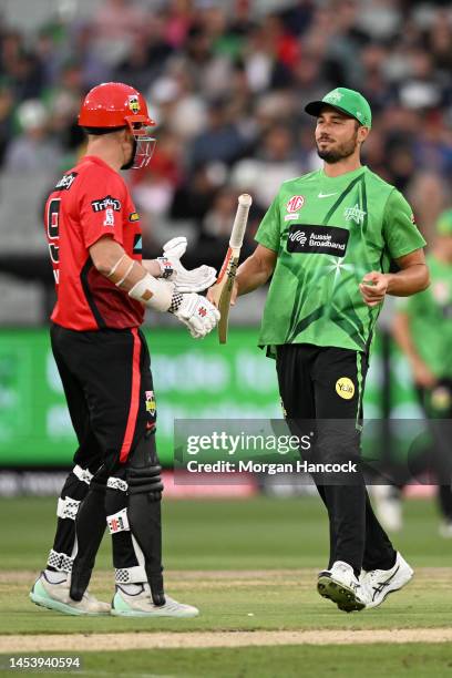 Marcus Stoinis of the Stars returns the bat of Shaun Marsh of the Renegades to him during the Men's Big Bash League match between the Melbourne Stars...