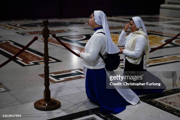 Nuns pray as Pope Emeritus Benedict XVI lies in state at St. Peter's Basilica on January 03, 2023 in Vatican City, Vatican. Joseph Aloisius Ratzinger...