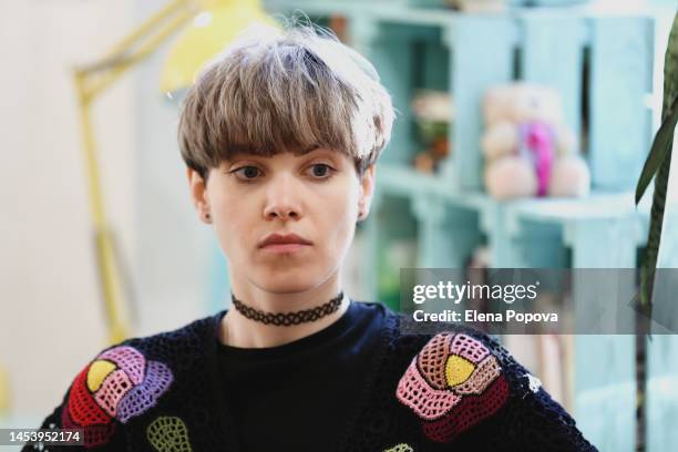 portrait young beautiful woman against colorful local cafe interior background - multi coloured dress stock-fotos und bilder