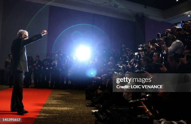 British director Ken Loach raises his fist as he poses during a photocall after he won the Prix du Jury for his film "The Angel's Share" at the 65th...