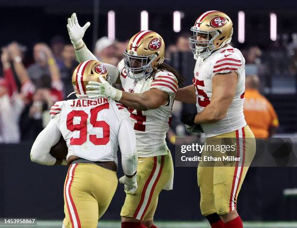 Defensive end Drake Jackson of the San Francisco 49ers is congratulated by linebacker Fred Warner and defensive end Jordan Willis after intercepting...