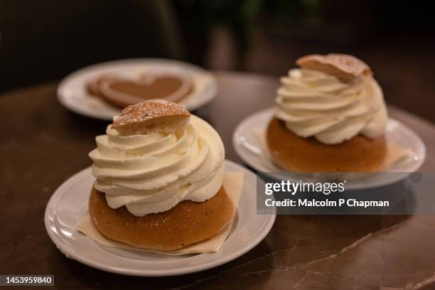 semlor or semla, cream buns with almond paste, eaten on, or before, shrove tuesday in sweden / scandinavia. also known as fastlagsbulle, laskiaispulla, vastlakukkel, fastelavnsbolle - shrovetide stock pictures, royalty-free photos & images