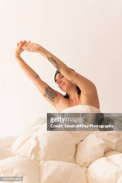 woman morning stretches in bed - hairy body woman stock pictures, royalty-free photos & images