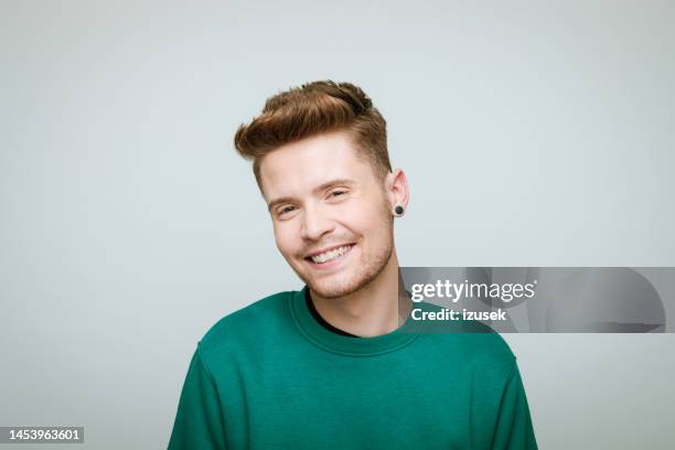 headshot of a young volunteer - man earring stock pictures, royalty-free photos & images