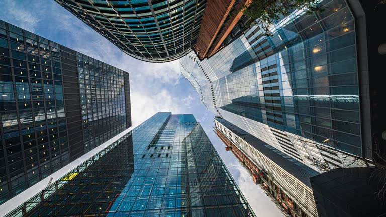 https://media.gettyimages.com/id/1453963806/video/time-lapse-low-angle-of-tall-corporate-buildings-skyscraper-with-reflection-of-clouds-among.jpg?b=1&s=640x640&k=20&c=H5lwWCLio3p-vbkka6GKmj197FziZG6yvtf52_PuyL0=
