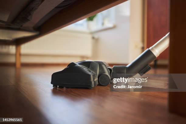 close-up of vacuum cleaner during cleaning dusty floor - aspirapolvere foto e immagini stock