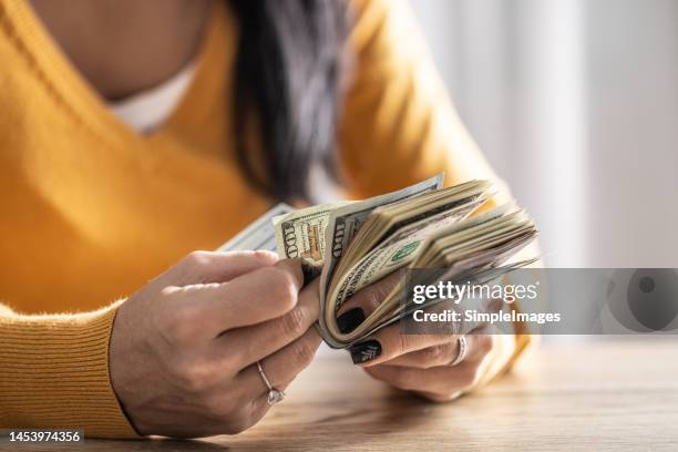 a woman counts many american bills - close up. - legislation change stock pictures, royalty-free photos & images