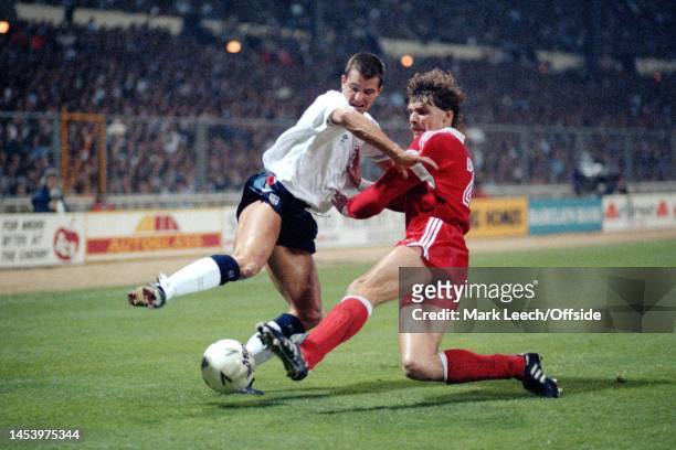 October 1990 Wembley - Qualifying Match - England v Poland - Steve Bull is tackled by Piot Czachowski.
