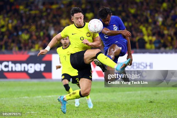 Darren Lok of Malaysia competes for the ball against Shakir Hamzah of Singapore in the first half during the AFF Mitsubishi Electric Cup Group B...