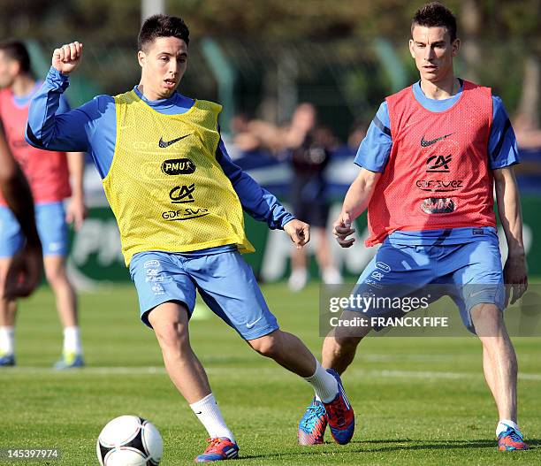 French national football team's midfielder Samir Nasri vies with defender Laurent Koscielny during a training session on May 28, 2012 in Le...