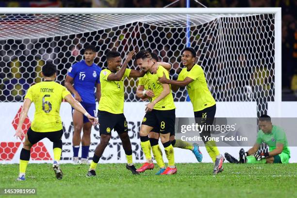 Stuart Wilkin of Malaysia celebrates with teammates after scoring a brace and the team's third goal against Singapore in the second half during the...