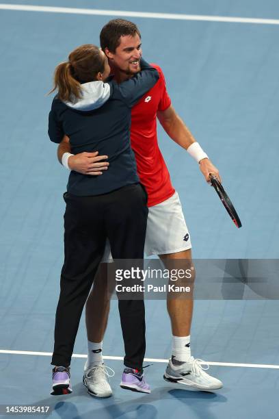 Borna Gojo of Croatia celebrates with team captain Iva Majoli after winning the Men's singles match against Adrian Mannarino of France during day six...