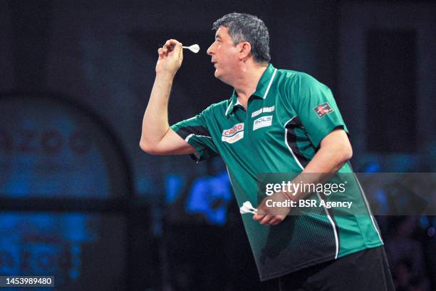 Mensur Suljovic of Austria in action during Day Seven of the Cazoo World Darts Championship at Alexandra Palace on December 22, 2022 in London,...