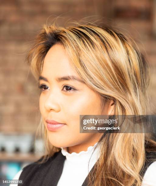 profile indoor portrait of young woman - soft smile stock pictures, royalty-free photos & images