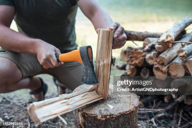 man preparing wood for the campfire. - axe stock pictures, royalty-free photos & images
