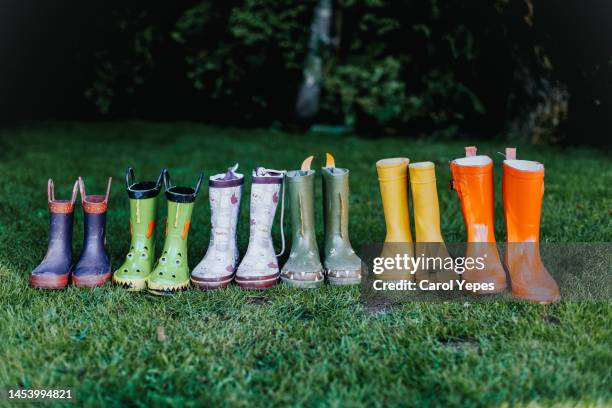 family's green wellington boots on back yard - shoes in a row stock pictures, royalty-free photos & images