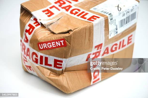 crushed posted package on white background - fragile sign stock pictures, royalty-free photos & images