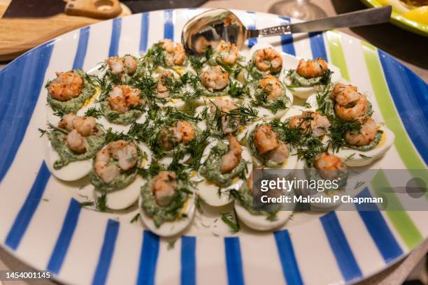 swedish julbord, christmas table - egg halves with crayfish tails and spinach - swedish culture stock pictures, royalty-free photos & images