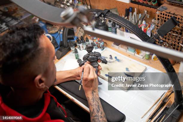 middle-aged latin man painting 3d printed figure - surreal painting stock pictures, royalty-free photos & images