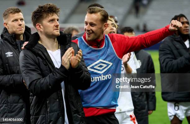 Thomas Foket, Kaj Sierhuis of Reims salute the supporters following the Ligue 1 match between Lille OSC and Stade Reims at Stade Pierre-Mauroy on...