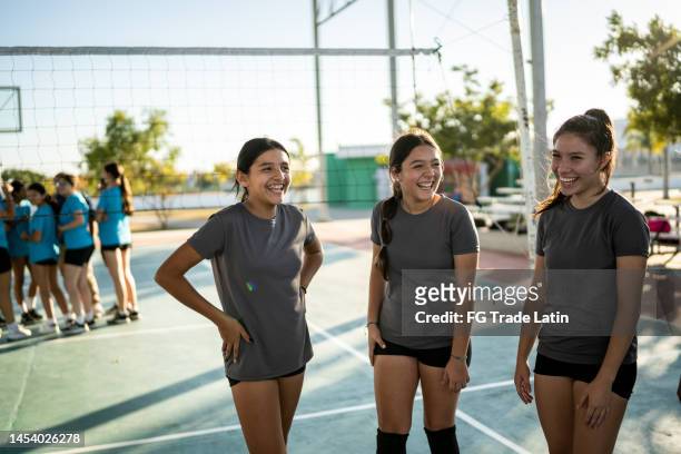 female volleyball team talking and having fun before the game - candid volleyball stock pictures, royalty-free photos & images