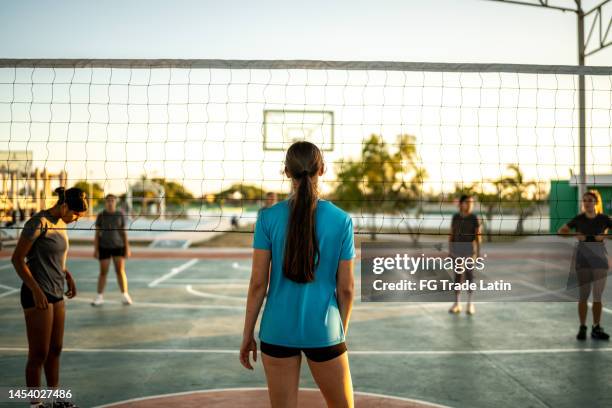 female volleyball player during a game at sports court - candid volleyball stock pictures, royalty-free photos & images