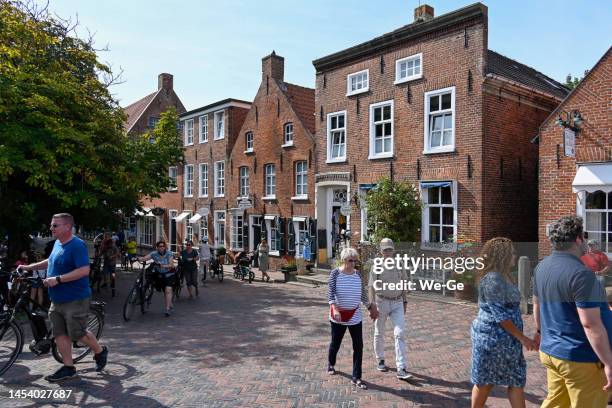 tourists and locals stroll through the market in greetsiel on the east frisian north sea coast. - north frisia stock pictures, royalty-free photos & images