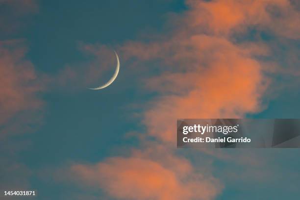 crescent moon during a sunset - crescent stock pictures, royalty-free photos & images