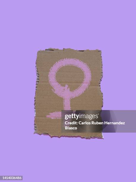 woman symbol on a cardboard poster. feminist concept - feminism stock pictures, royalty-free photos & images