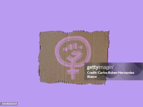 feminist symbol on a cardboard poster. feminist concept - igualdad de género fotografías e imágenes de stock