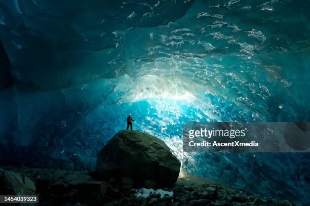 man inside a glacial ice cave - caves bildbanksfoton och bilder