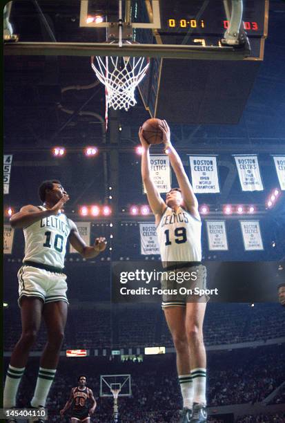 Don Nelson of the Boston Celtics grabs a rebound as teammate Jo Jo White looks on against the New York Knicks during an NBA basketball game circa...