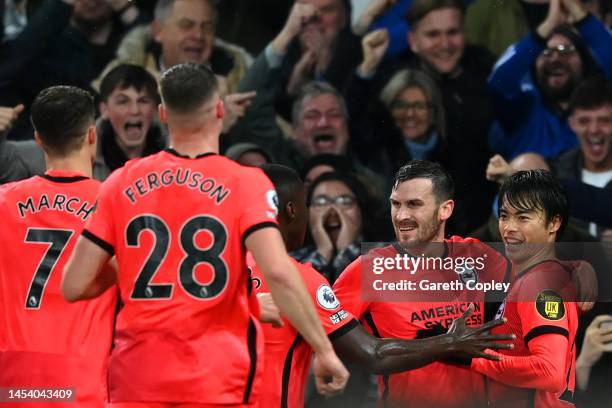Kaoru Mitoma of Brighton & Hove Albion celebrates with teammates after scoring the team's first goal during the Premier League match between Everton...