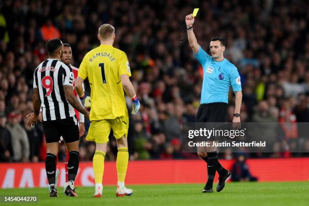 Referee Andy Madley shows a yellow card to Callum Wilson of Newcastle United during the Premier League match between Arsenal FC and Newcastle United...