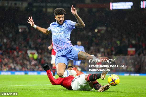 Casemiro of Manchester United slides in to stop Philip Billing of Bournemouth during the Premier League match between Manchester United and AFC...