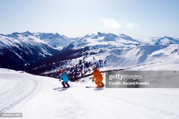 couple on a ski vacation - whistler mountain stockfoto's en -beelden