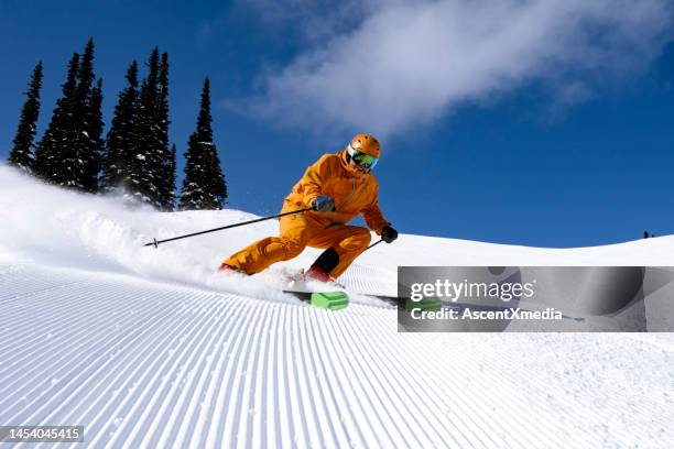 skiing groomed runs in the mountains - skiing and snowboarding stockfoto's en -beelden