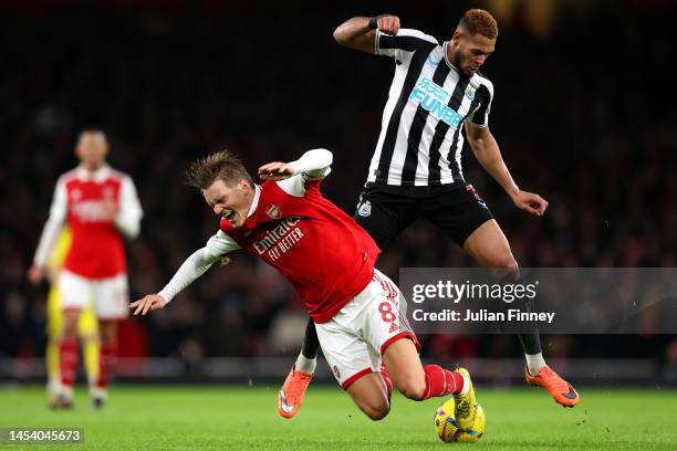 Martin Odegaard of Arsenal battles for possession with Joelinton of Newcastle United during the Premier League match between Arsenal FC and Newcastle...