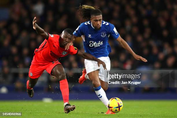 Alex Iwobi of Everton runs with the ball from Moises Caicedo of Brighton & Hove Albion during the Premier League match between Everton FC and...