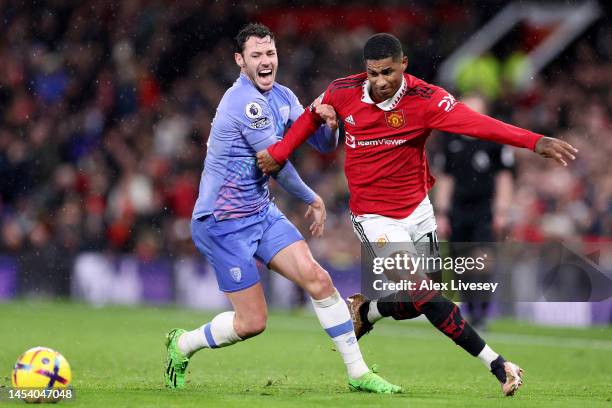 Marcus Rashford of Manchester United runs with the ball whilst under pressure from Adam Smith of AFC Bournemouth during the Premier League match...