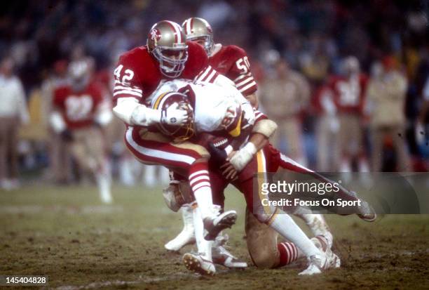 Washington, D.C. Ronnie Lott of the San Francisco 49ers tackles Art Monk the Washington Redskins during an NFL football game November 17, 1986 at...