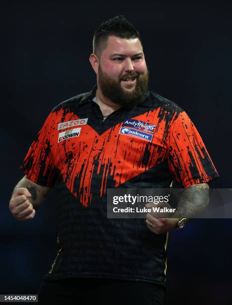 Michael Smith of England celebrates a nine dart finish during the finals against Michael van Gerwen of Netherlands during Day Fourteen of the Cazoo...