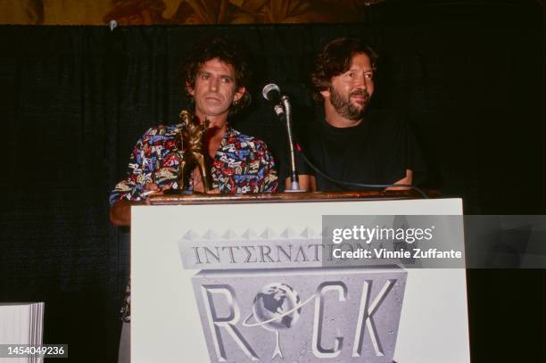 Keith Richards and Eric Clapton stand at a podium with a "Dancing Elvis" statuette at the Rock and Roll Hall of Fame, United States, 18th January...