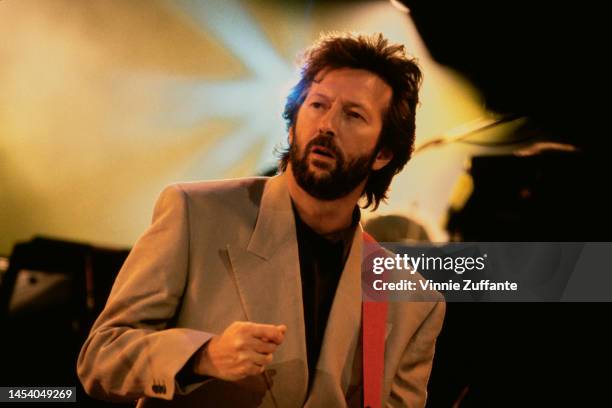 Eric Clapton performing with Mark Knopfler of Dire Straits at the Nelson Mandela 70th Birthday Tribute concert at Wembley Stadium in London, England...