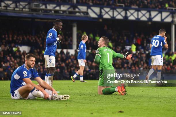 Jordan Pickford and Idrissa Gueye of Everton react after Brighton & Hove Albion's fourth goal during the Premier League match between Everton FC and...