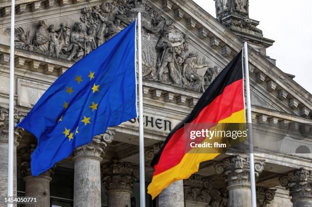 german- and eu-flag with reichstag building - deutscher bundestag (berlin, germany) - german flag wallpaper stock pictures, royalty-free photos & images