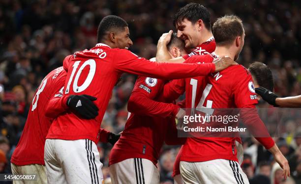 Luke Shaw of Manchester United celebrates after scoring the team's second goal with teammates during the Premier League match between Manchester...