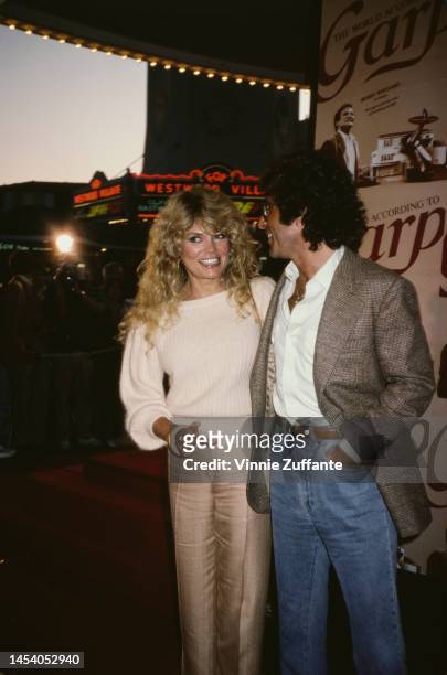Dyan Cannon attends "The World According to Garp" premiere with an unidentified man, United States, 20th July 1982.
