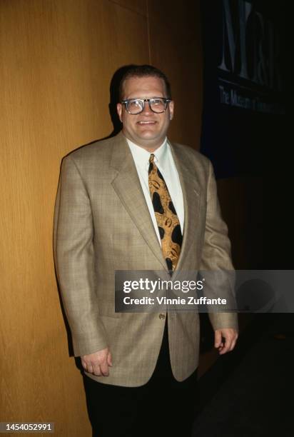 Drew Carey poses with others next to a sign that reads "MT&R The Museum of Television and Radio" in Los Angeles, California, United States, circa...