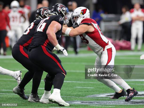 Watt of the Arizona Cardinals against Kaleb McGary and Chris Lindstrom of the Atlanta Falcons at Mercedes-Benz Stadium on January 01, 2023 in...